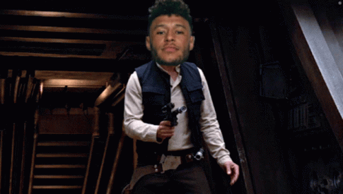 Bearded Man Holding Gun In Dark Room GIF