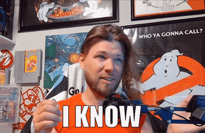Bearded Man Holding I Know Sign GIF