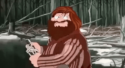 Bearded Man Holding Knife In Forest GIF