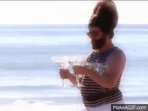 Bearded Man Holding Martini Glasses GIF