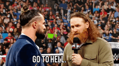 Bearded Man Holding Mic Talking Another In Ring GIF