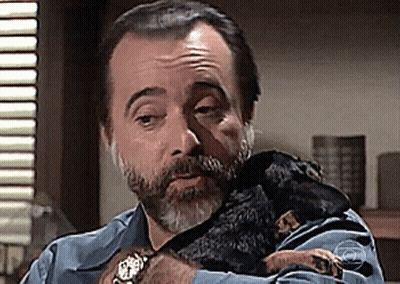 Bearded Man Holding Small Black Dog GIF
