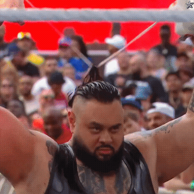 Bearded Man Holding Stick In Front Of Crowd GIF