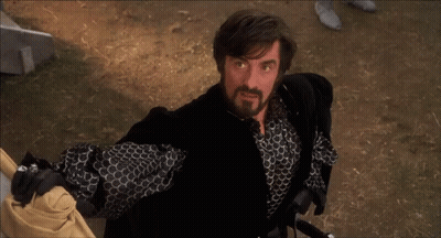 Bearded Man Holding Sword In Black Jacket GIF