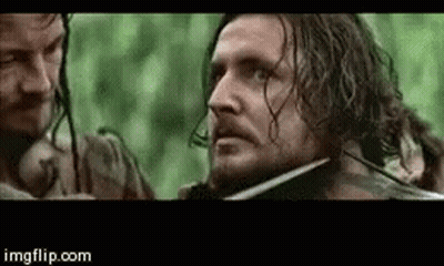 Bearded Man Holding Sword In Mouth With Onlooker GIF