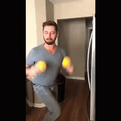 Bearded Man Holding Two Lemons GIF