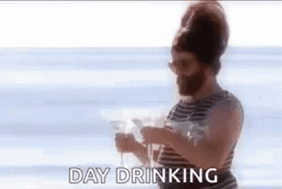 Bearded Man Holding Wine On Beach GIF