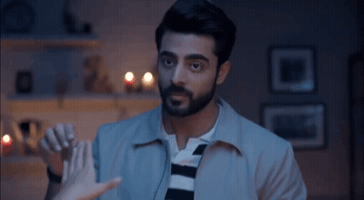 Bearded Man Holding Woman's Hand In Living Room GIF