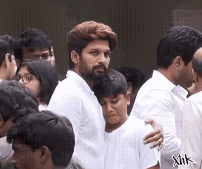 Bearded Man Hugging Boy In Crowd GIF