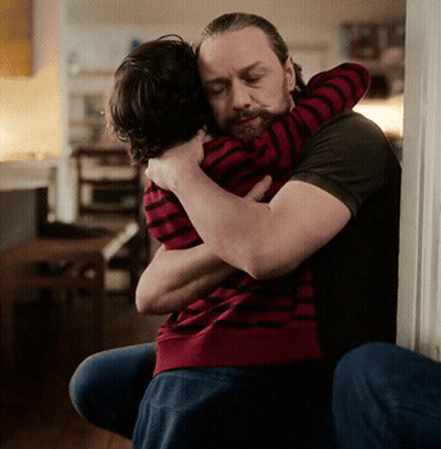 Bearded Man Hugging Child in Red and Black Striped Shirt