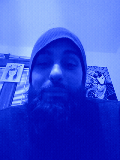 Bearded Man In Beanie Under Blue Light GIF