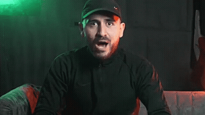 Bearded Man In Black Hat Screaming In Dark Room GIF