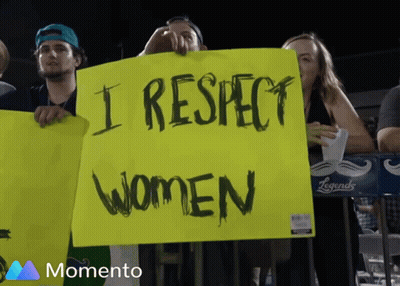 Bearded Man In Black Hat Smiling Next To Woman In Black Dress GIF