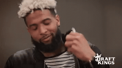Bearded Man In Black Jacket And Striped Shirt Holding Necklace GIF