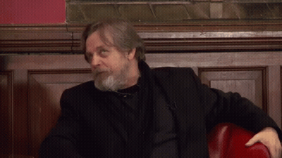 Bearded Man In Black Jacket Sitting On Red Chair GIF