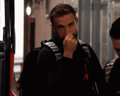 Bearded Man In Black Nike Shirt Holding Nose GIF
