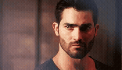 Bearded Man in Black Shirt Looking at Camera