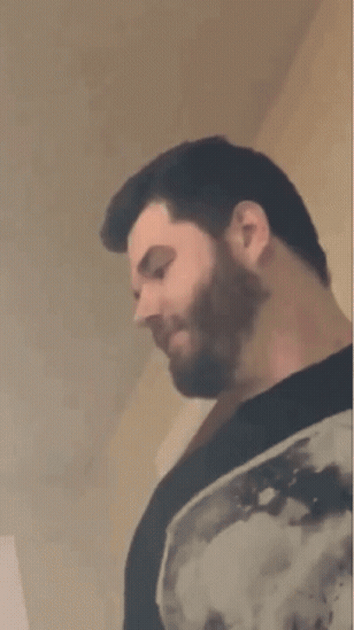Bearded Man In Black Shirt Looking Down GIF