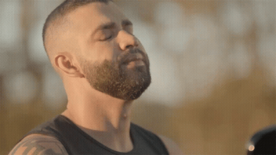 Bearded Man In Black Tank Top Eyes Closed Looking Down GIF