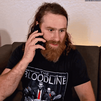 Bearded Man In Bloodline Shirt On Phone GIF