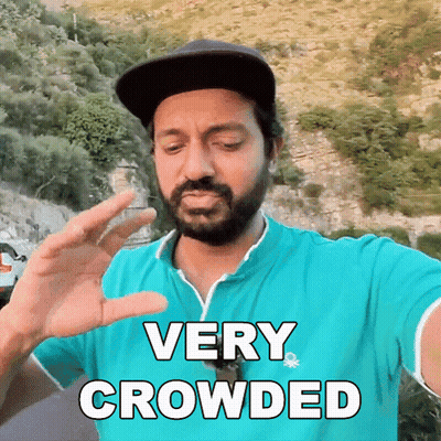 Bearded Man In Blue Shirt And Hat Saying Very Crowded GIF