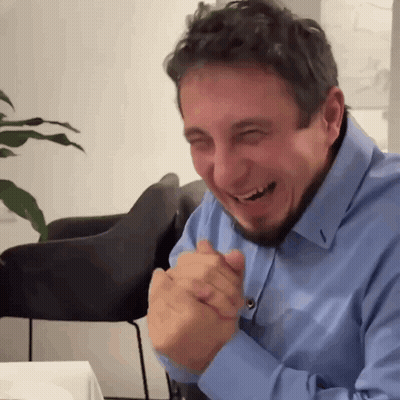 Bearded Man In Blue Shirt Laughing Hands Folded GIF