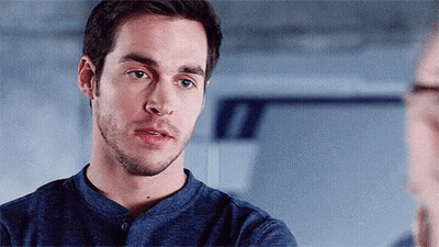 Bearded Man In Blue Shirt Looking At Another Man GIF