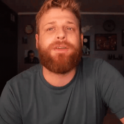 Bearded Man In Blue Shirt Looking At Camera GIF