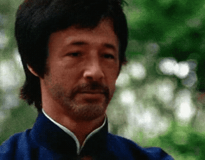 Bearded Man In Blue Shirt Looking At Camera GIF