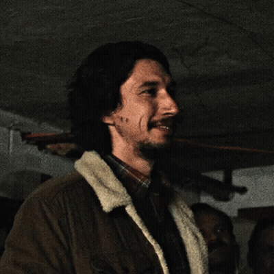 Bearded Man In Brown Jacket And Plaid Shirt Smiling GIF