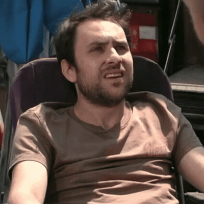 Bearded Man In Chair Wearing Guess T-Shirt GIF