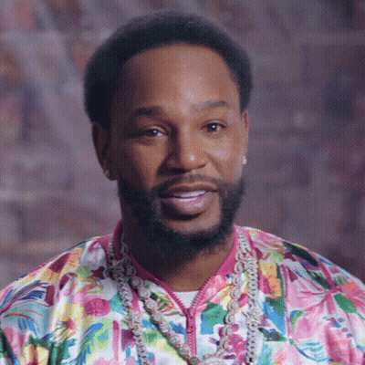 Bearded Man In Floral Shirt And Necklace GIF