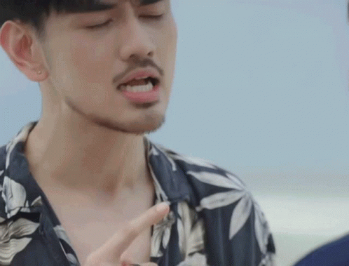 Bearded Man in Floral Shirt Pointing at Chest