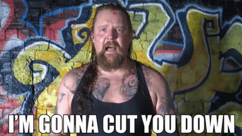 Bearded Man In Front Of Graffiti I'm Gonna Cut You Down GIF
