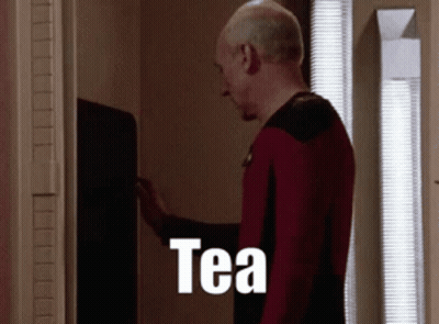 Bearded Man In Front Of Screen With Letter T GIF