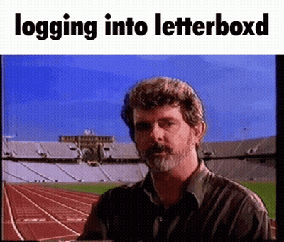 Bearded Man In Front Of Stadium Logging Into Letterboxd GIF