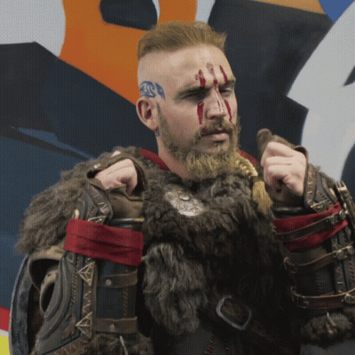 Bearded Man In Fur Coat Holding Sword GIF