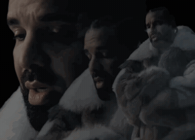 Bearded Man In Fur Coat Surrounded By Men GIF