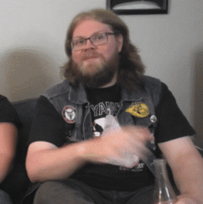 Bearded Man In Glasses And Black Shirt Saying Yank GIF