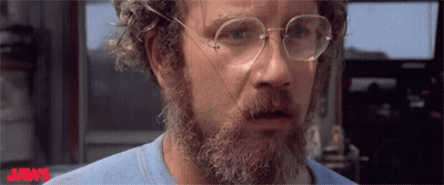 Bearded Man In Glasses And Blue Shirt Saying Jaws GIF