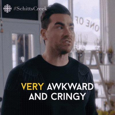 Bearded Man In Glasses And Suit Sitting On Couch GIF