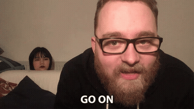 Bearded Man In Glasses Tells Woman Go On GIF