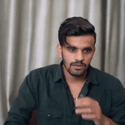 Bearded Man In Green Shirt And Necklace GIF