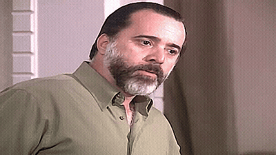Bearded Man In Green Shirt Looking At Camera GIF
