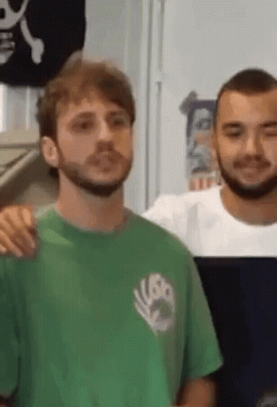 Bearded Man In Green Shirt Next To Man In White Shirt GIF