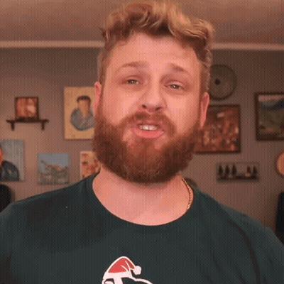 Bearded Man In Green Shirt With Santa Hat GIF