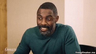 Bearded Man In Green Sweater Smiling In Chair GIF