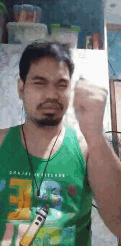 Bearded Man In Green Tank Top Holding Remote Control GIF