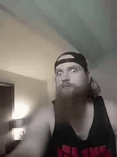 Bearded Man In Hat And Black Tank Top Making Funny Face GIF