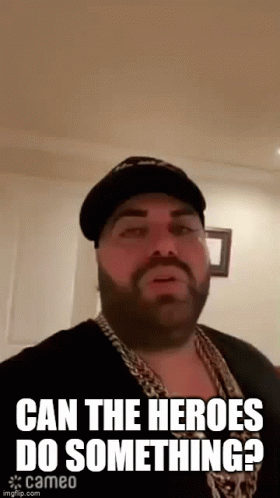 Bearded Man In Hat And Chains Saying Can The Heroes Do Something GIF